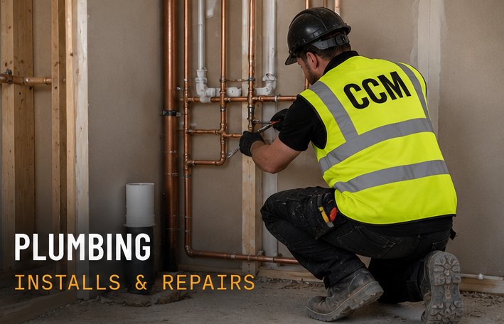 Plumber in a CCM hi-vis vest fitting copper pipework. Plumbing: installs and repairs